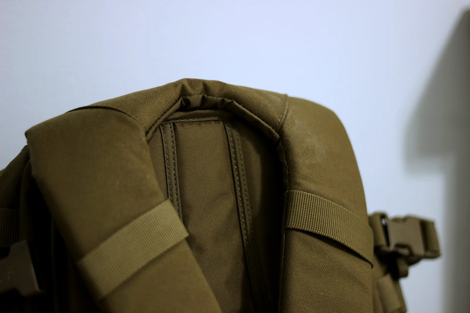 The top haul handle of the pack stitched into the yoke