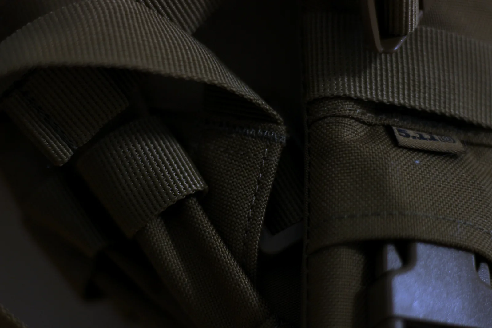 Compression straps and side-release buckles running down the flank of the pack