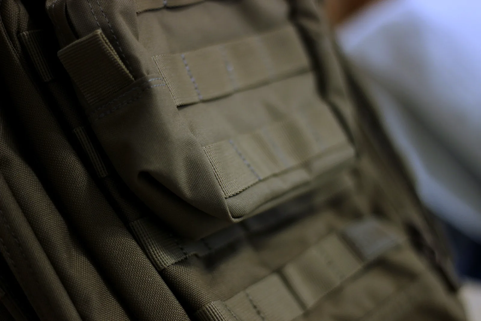 The front face of the pack showing rows of MOLLE webbing stitched across it