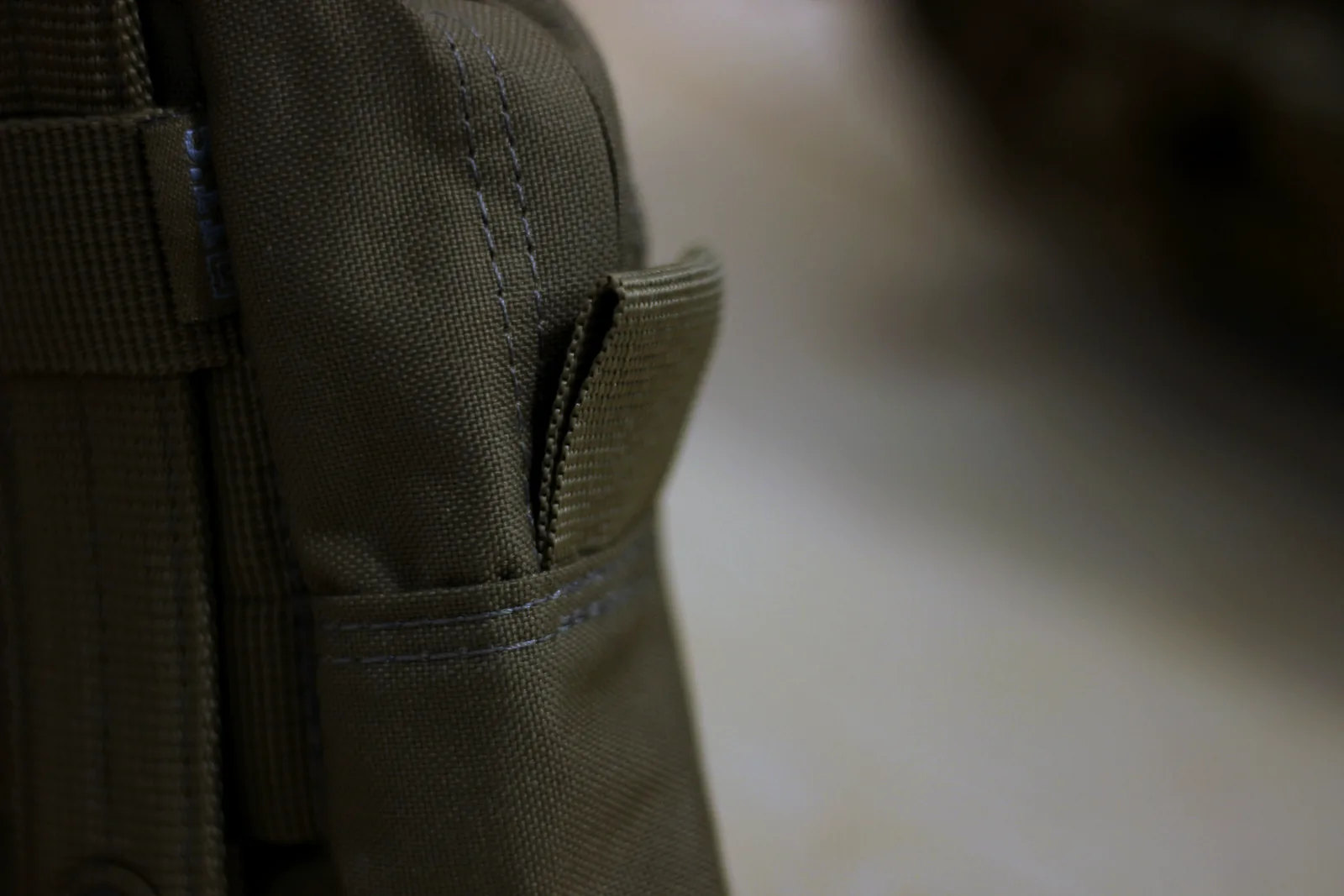 A narrow vertical slip pocket set into the side of the pack