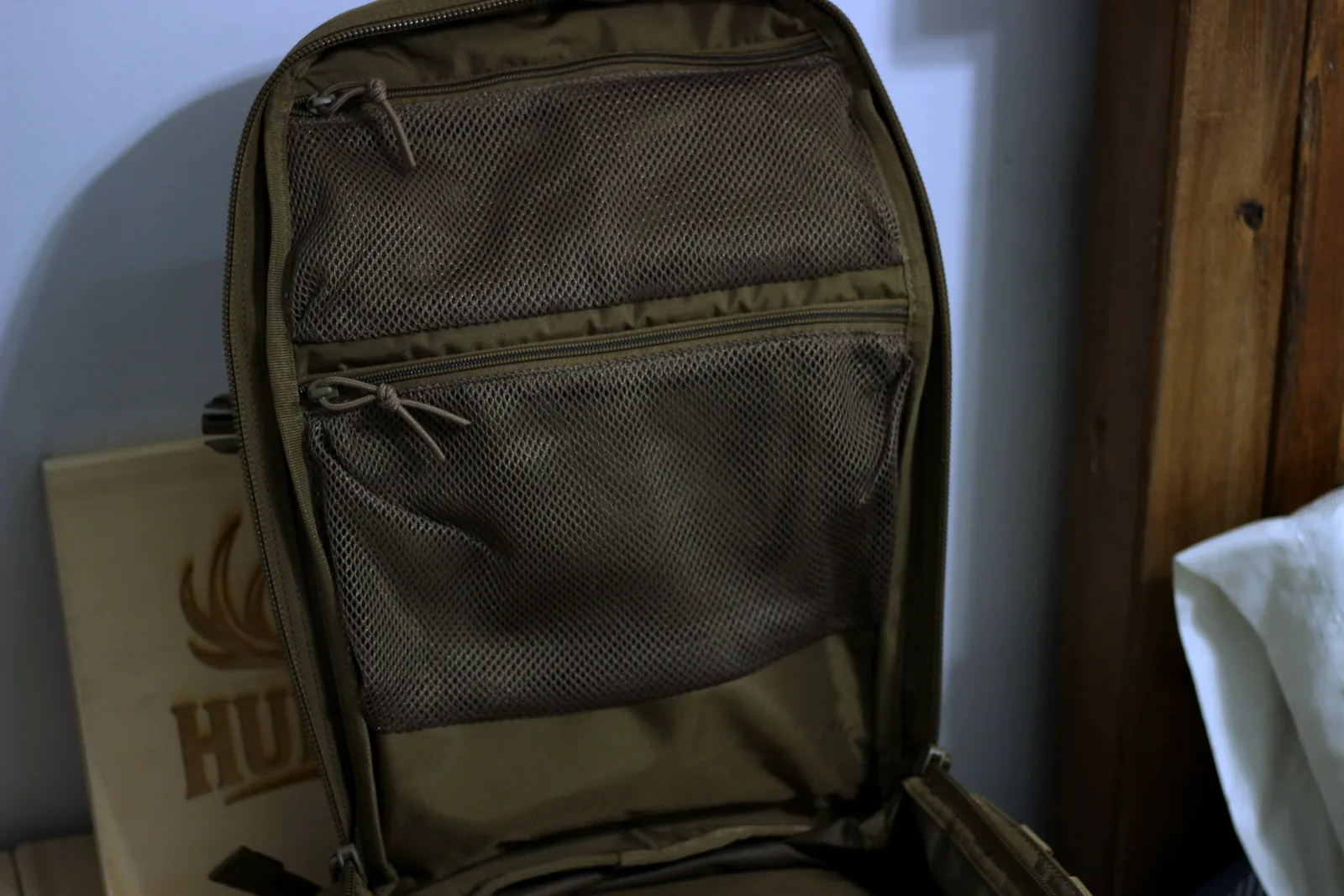 The RUSH 12 stood open showing the full internal admin panel with its zipped mesh pockets