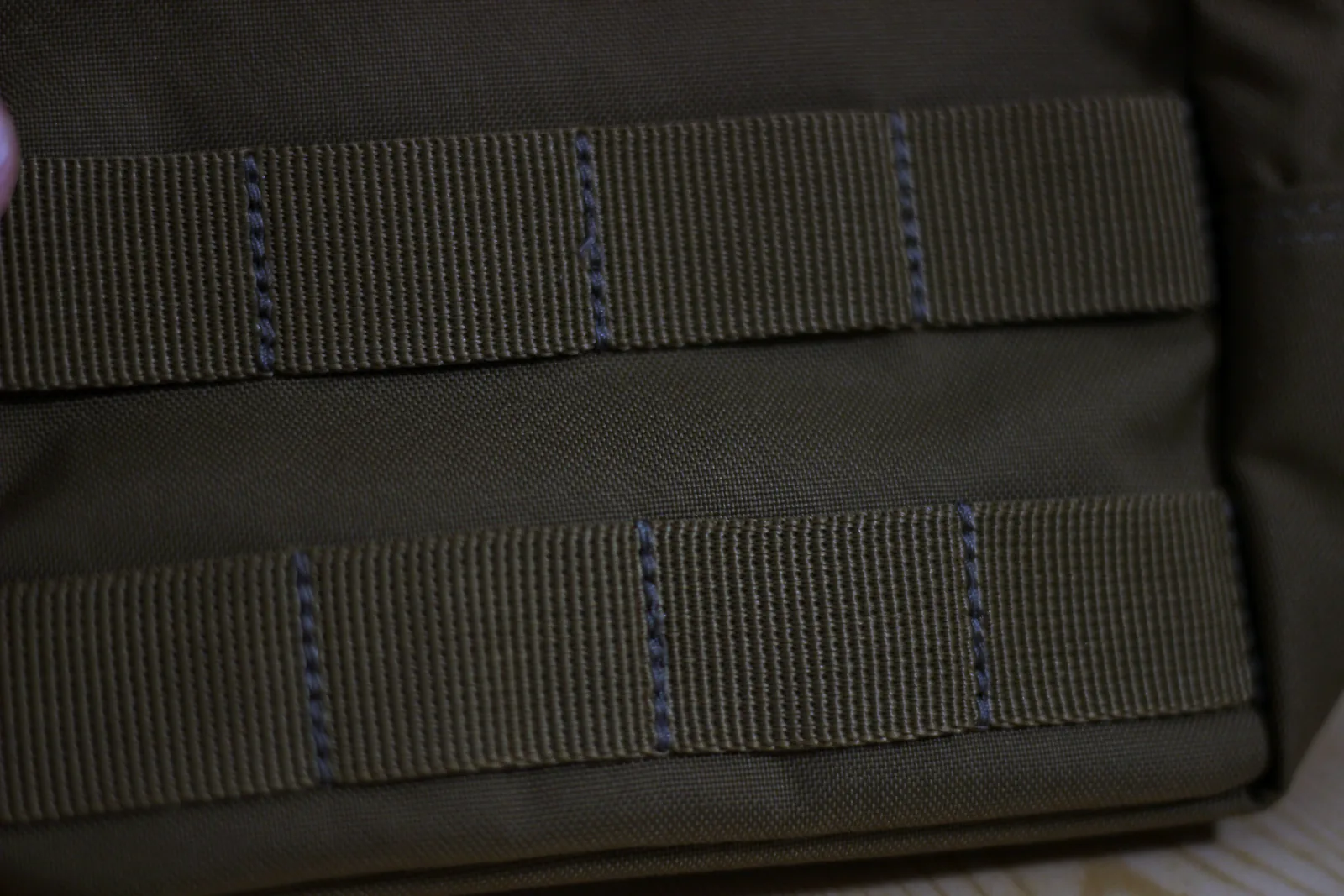 Rows of MOLLE webbing stitched across the face of the 6.6 pouch