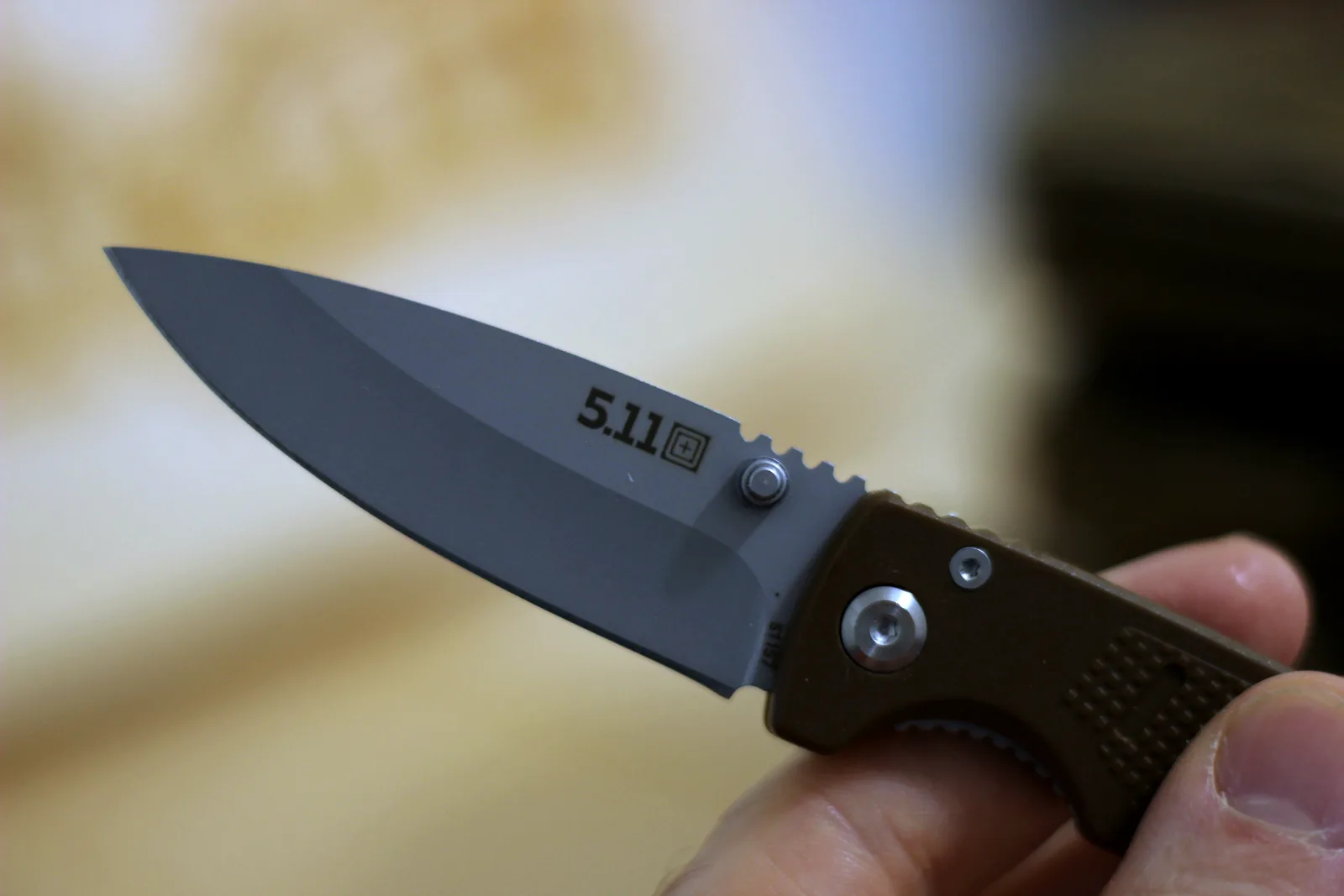 The 5.11 mark laser-etched on the flat of the knife blade