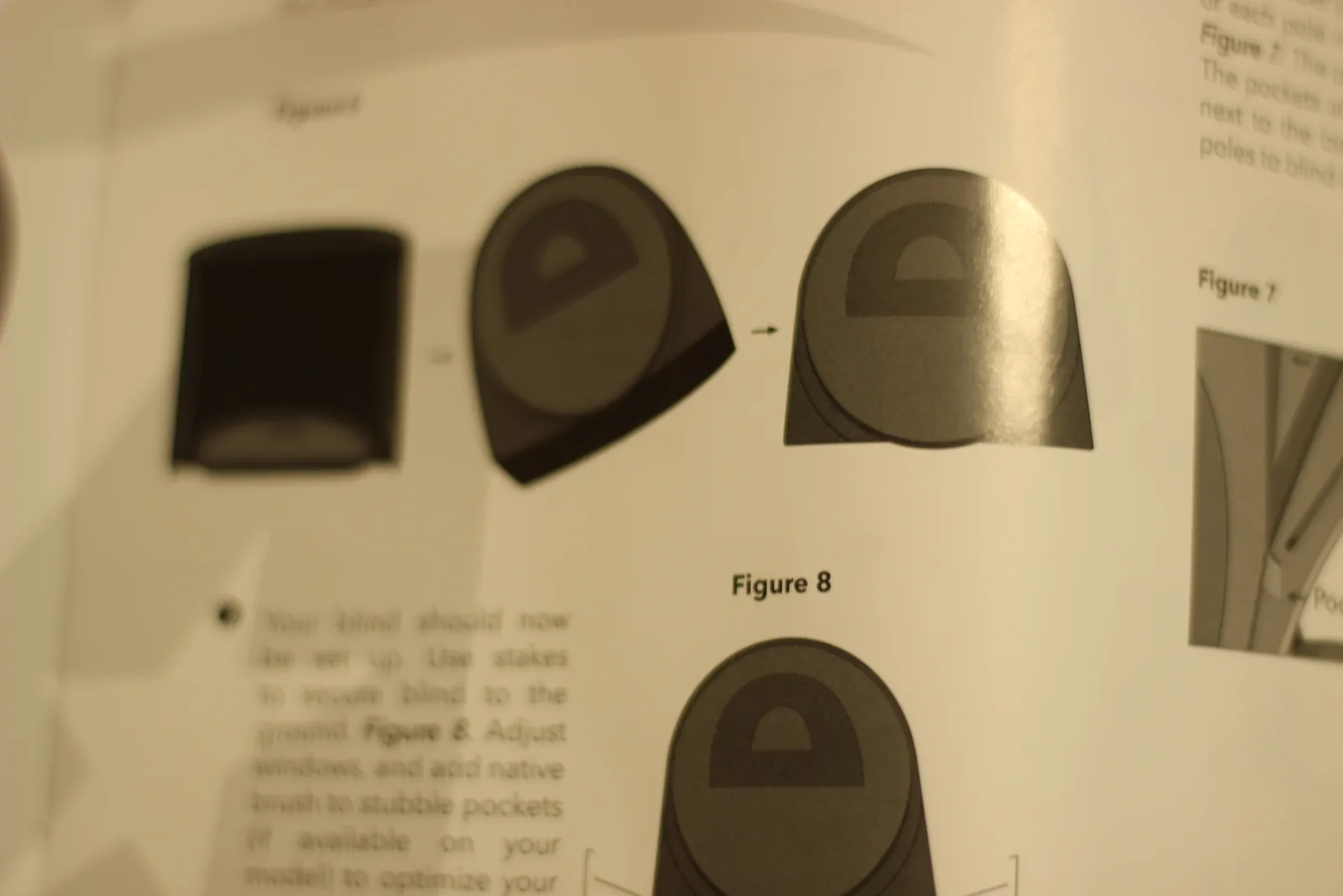 A page from the instruction manual showing line diagrams of the blind being unfolded and staked