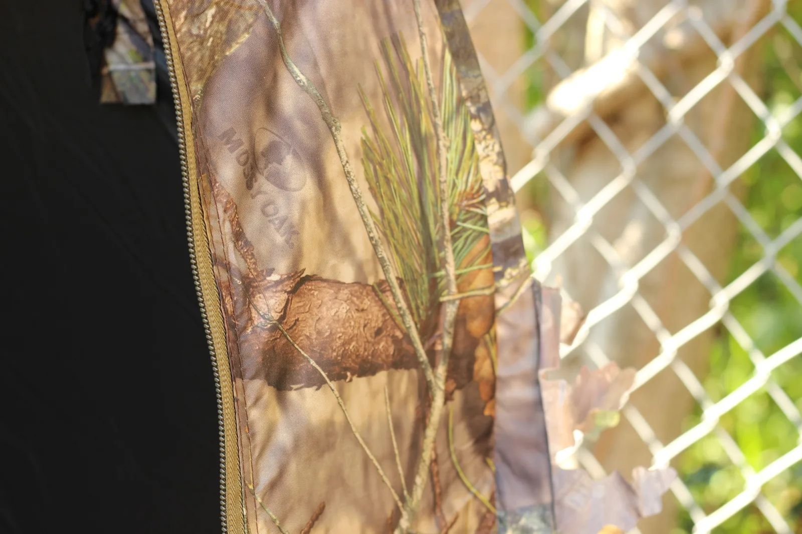 A zip run down the blind shell with a fabric brush loop stitched alongside