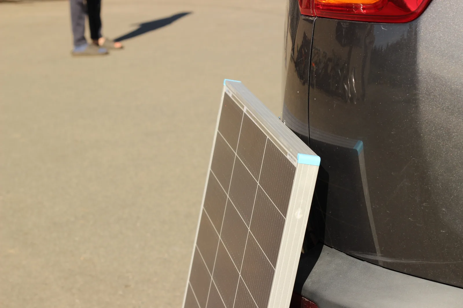 Solar panel angled against vehicle for optimal sun