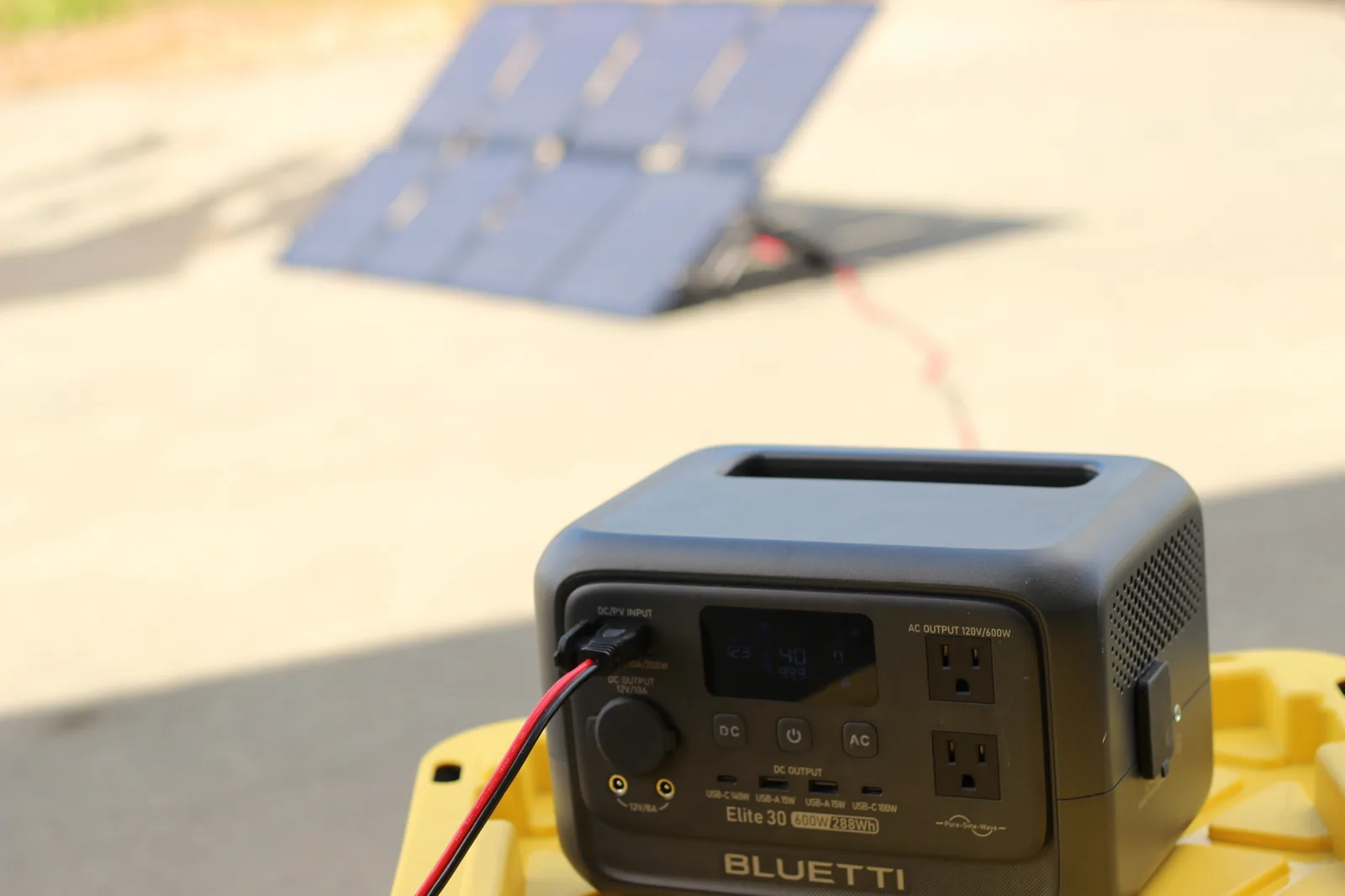 The panel propped and angled in the background with the Elite 30 power station in the foreground showing its display