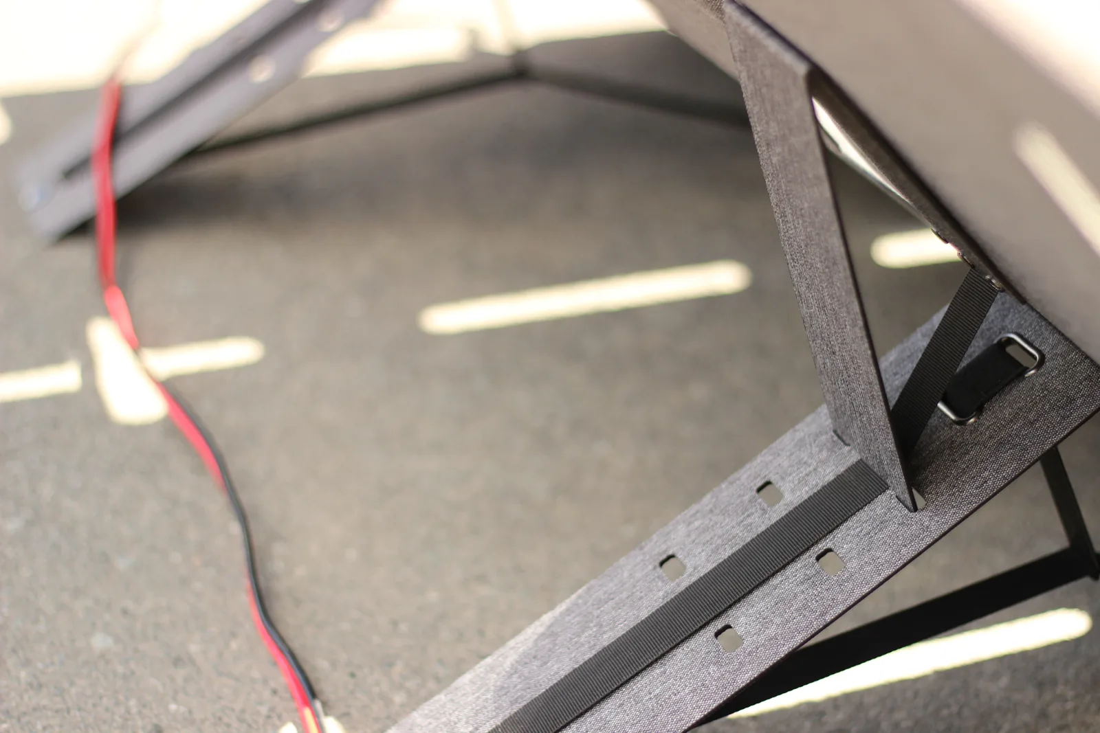Side view of the kickstand forming a triangle between the panel back and the ground