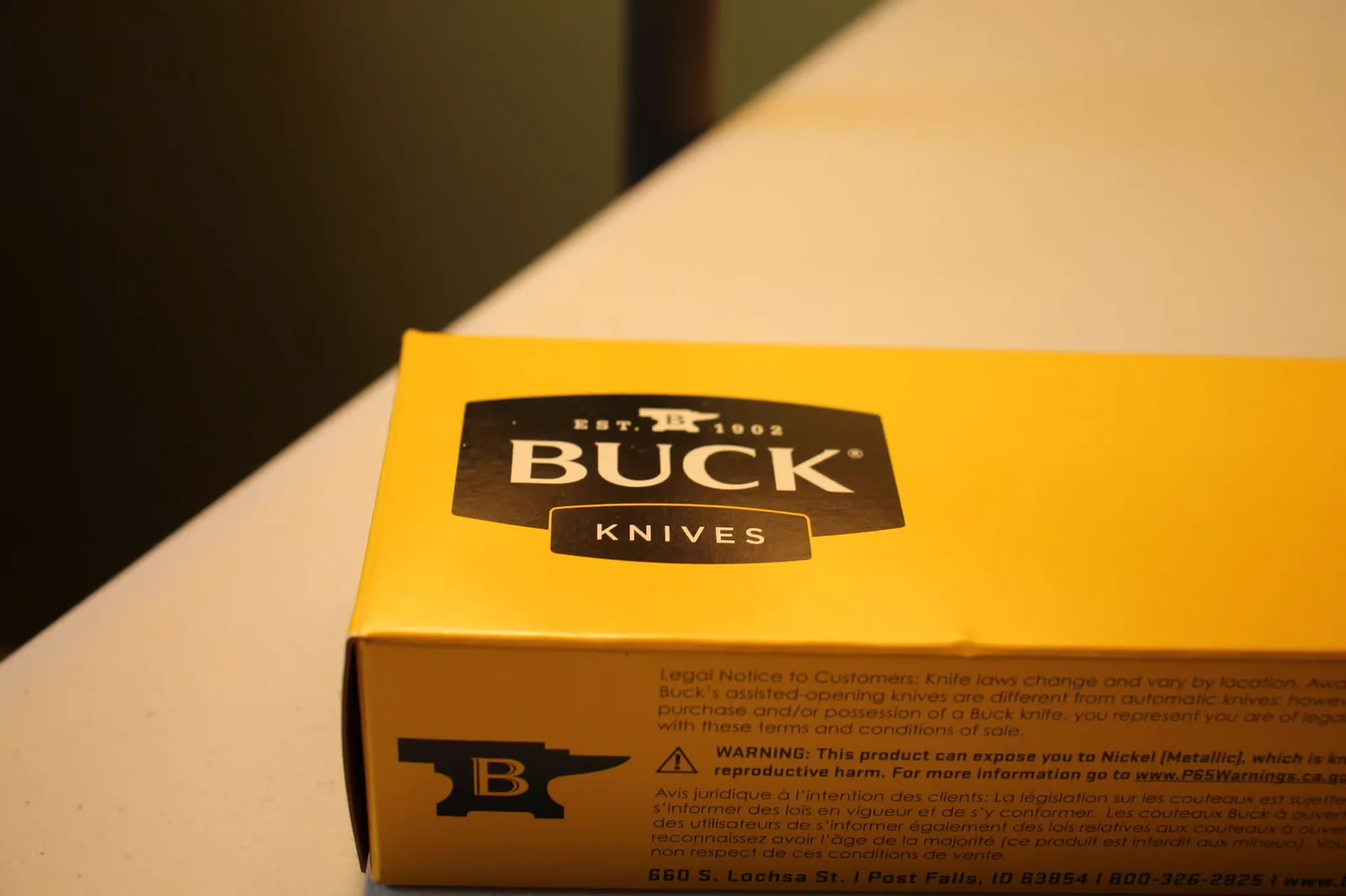 Side of Buck box showing legal copy, Post Falls Idaho address, and bilingual knife notice