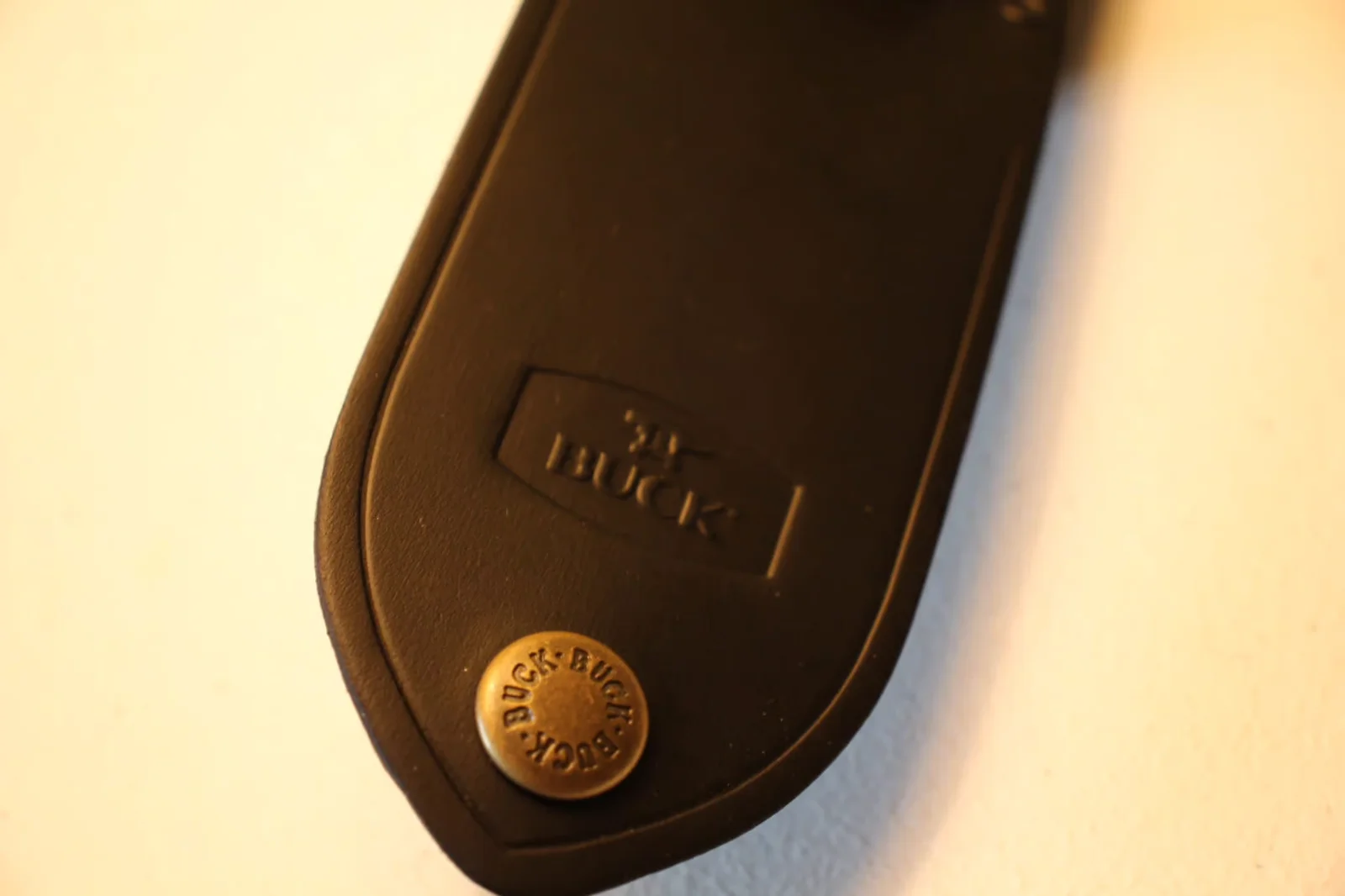 Back of leather sheath showing embossed BUCK rectangle stamp and brass rivet