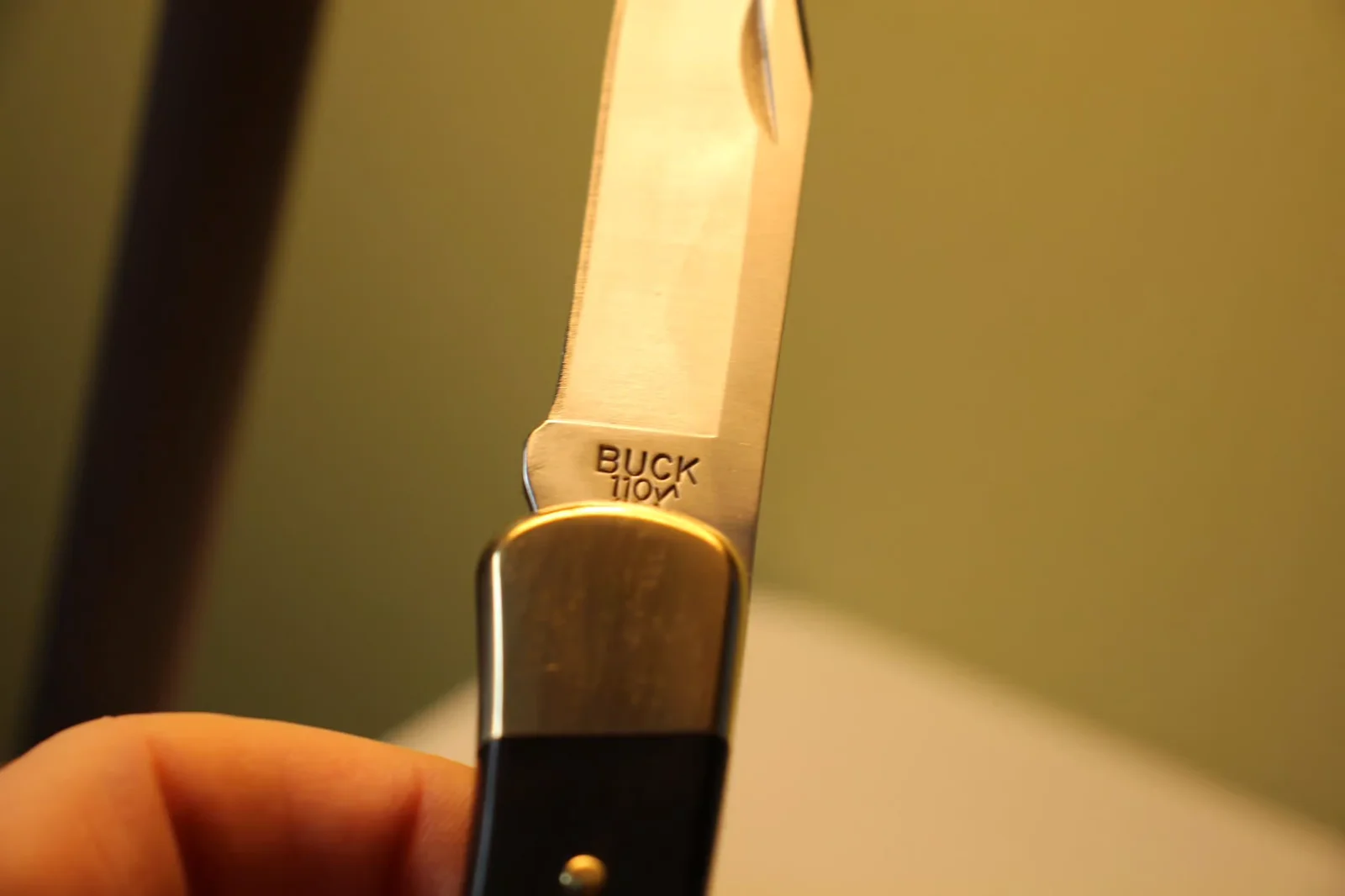 Close-up of the BUCK 110 stamp etched into the ricasso of the blade