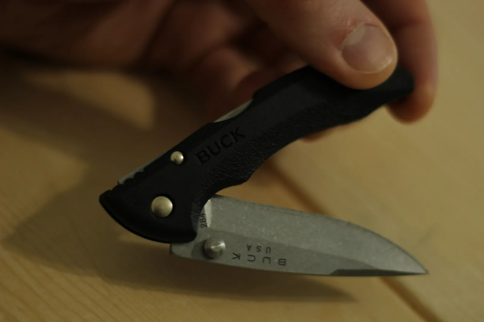 The knife part-open in one hand with the 284 model stamp visible on the exposed tang