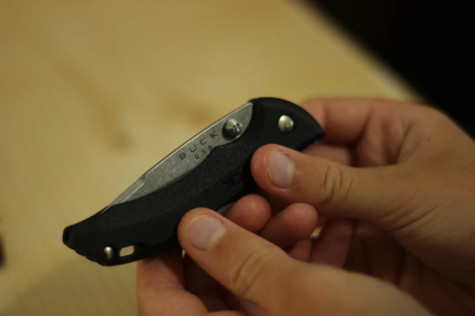 The closed knife lying across an open palm with the fingers curled around it