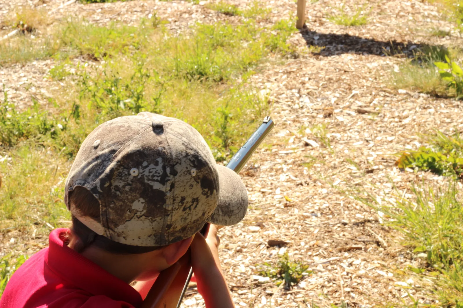 The 8-year-old shoulders the Buck 105 and aims downrange