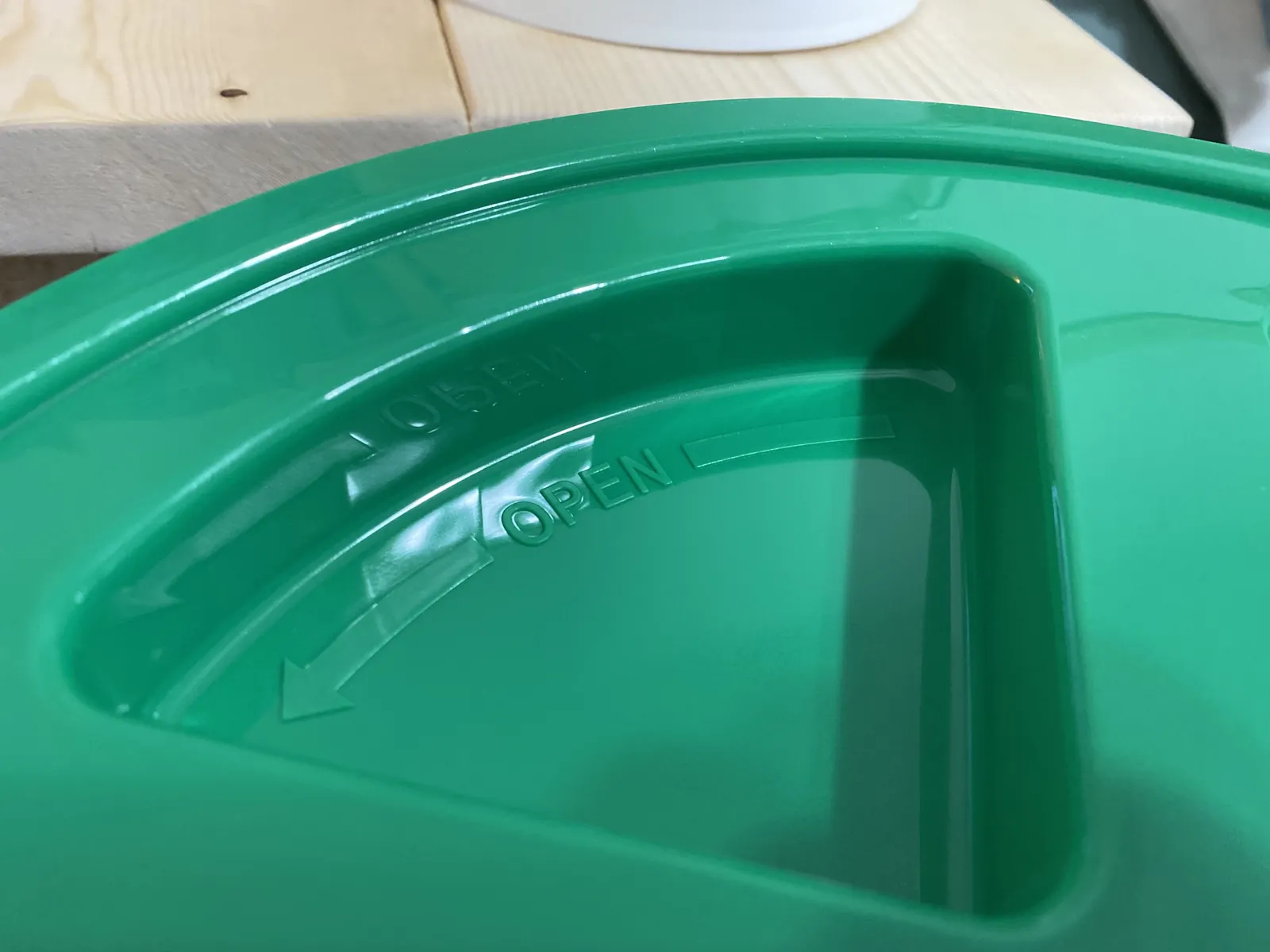 Close-up of the GAMMA Seal Lid showing the molded "OPEN" arrow indicator near the central handle slot