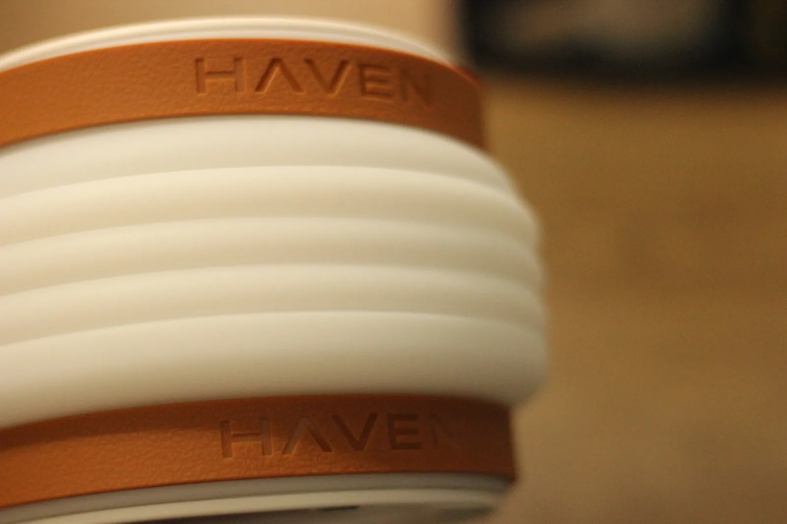 Close-up of the two HAVEN-stamped tan TPE straps on the lantern