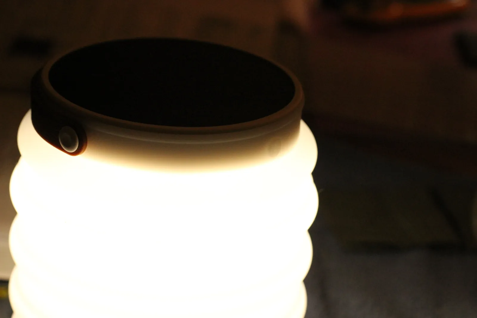 Close-up of the HAVEN 10000 lit, showing the power button on the lantern rim