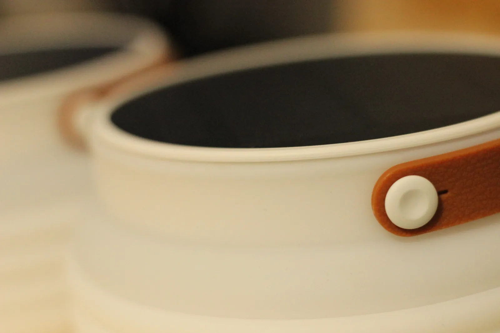 Detail of the HAVEN 10000 solar panel edge and the leather-look strap pull at the lantern's rim