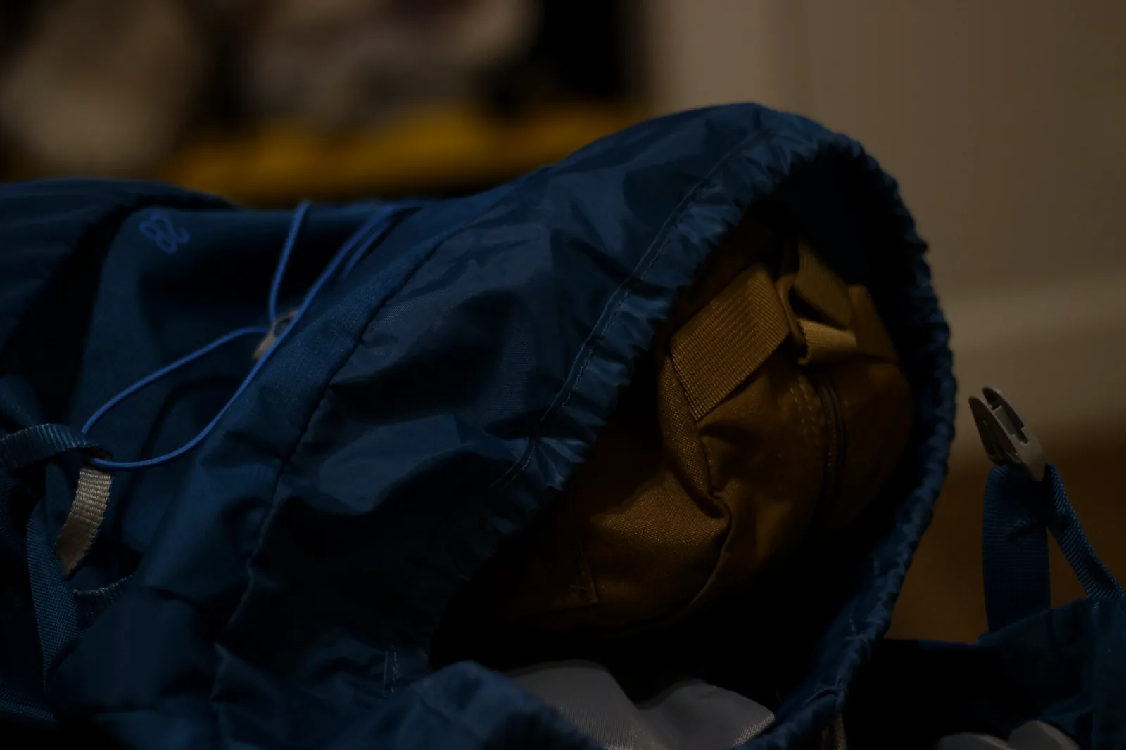 The coyote chair case sitting inside the open main compartment of a blue daypack