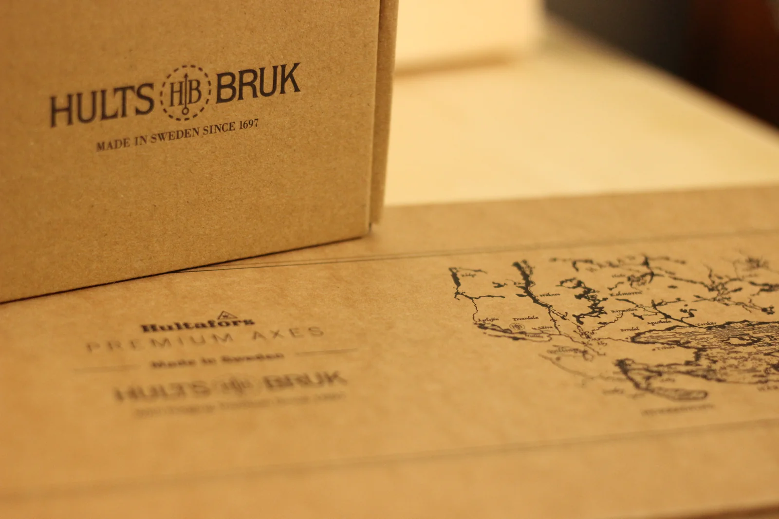 Close-up of the Hults Bruk grinding stone box with HULTS HB BRUK logo and MADE IN SWEDEN SINCE 1697 stamped underneath
