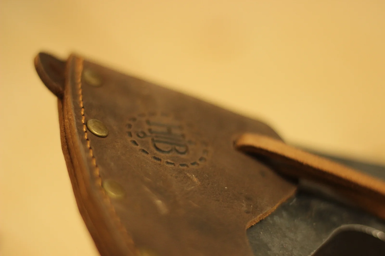 Top-down view of the axe head poll showing the wooden handle plug seated in the eye with the steel wedge driven through it
