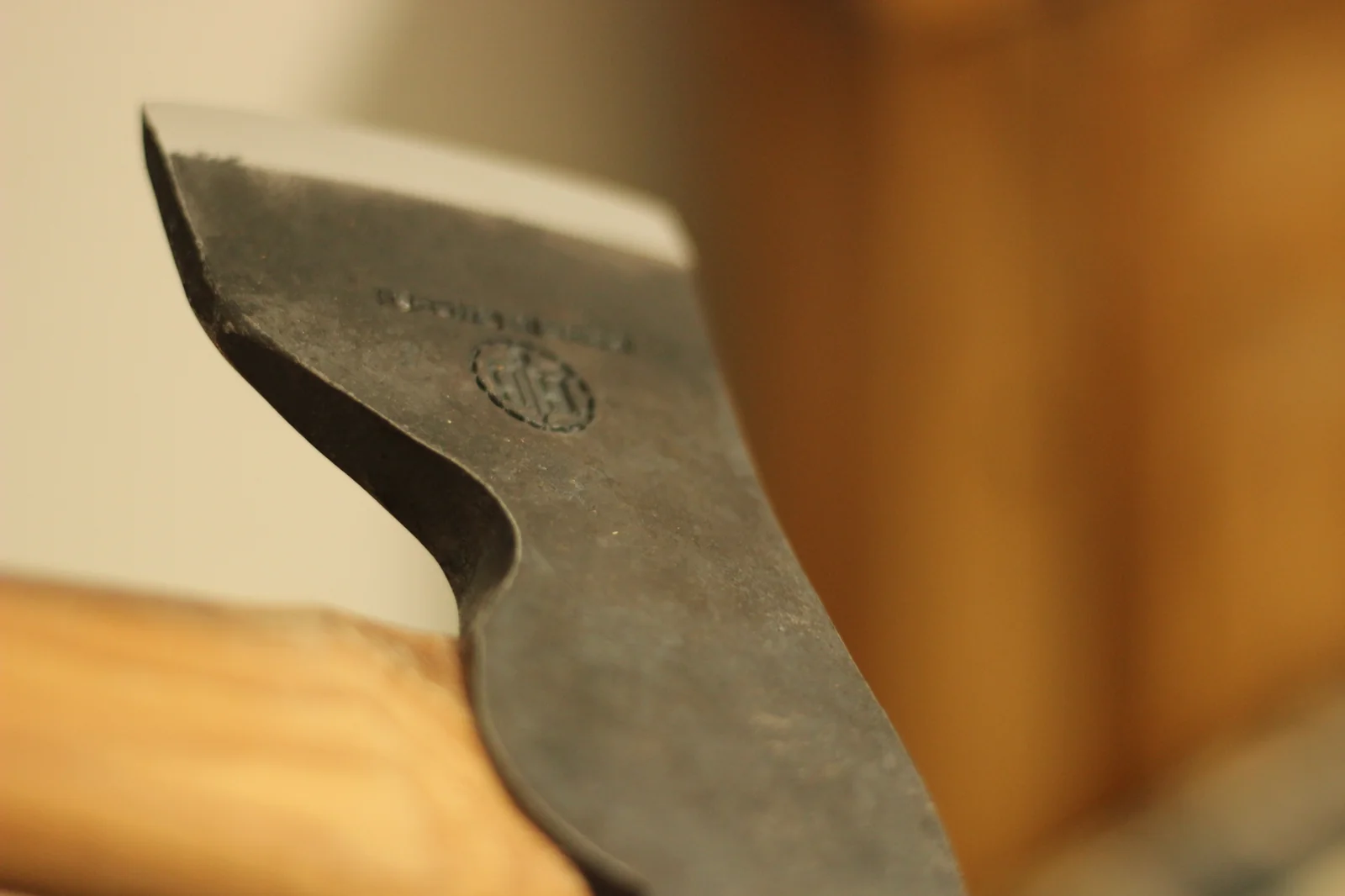 Full side profile of the axe head showing the squared poll at the back and the curved cutting edge at the front