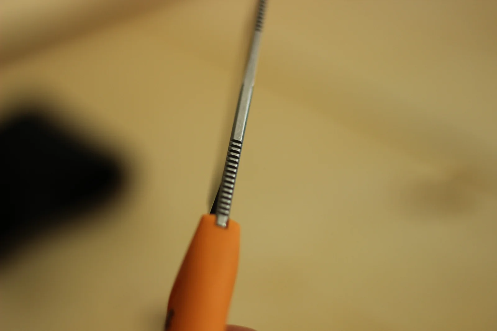 Macro of the spine of the 1882 blade showing the jimping cut into the spine of the smaller blade