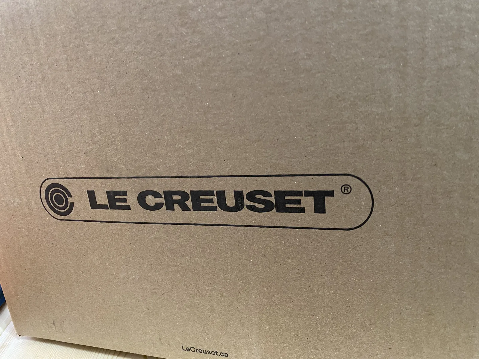 Outer shipping box with Le Creuset wordmark and lecreuset.ca URL