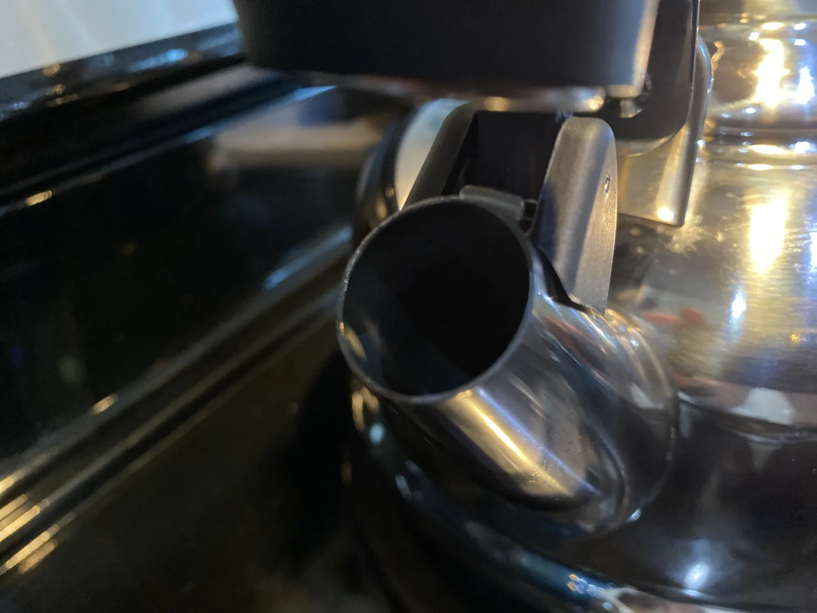 Whistle cover in the open position, viewed straight down the spout