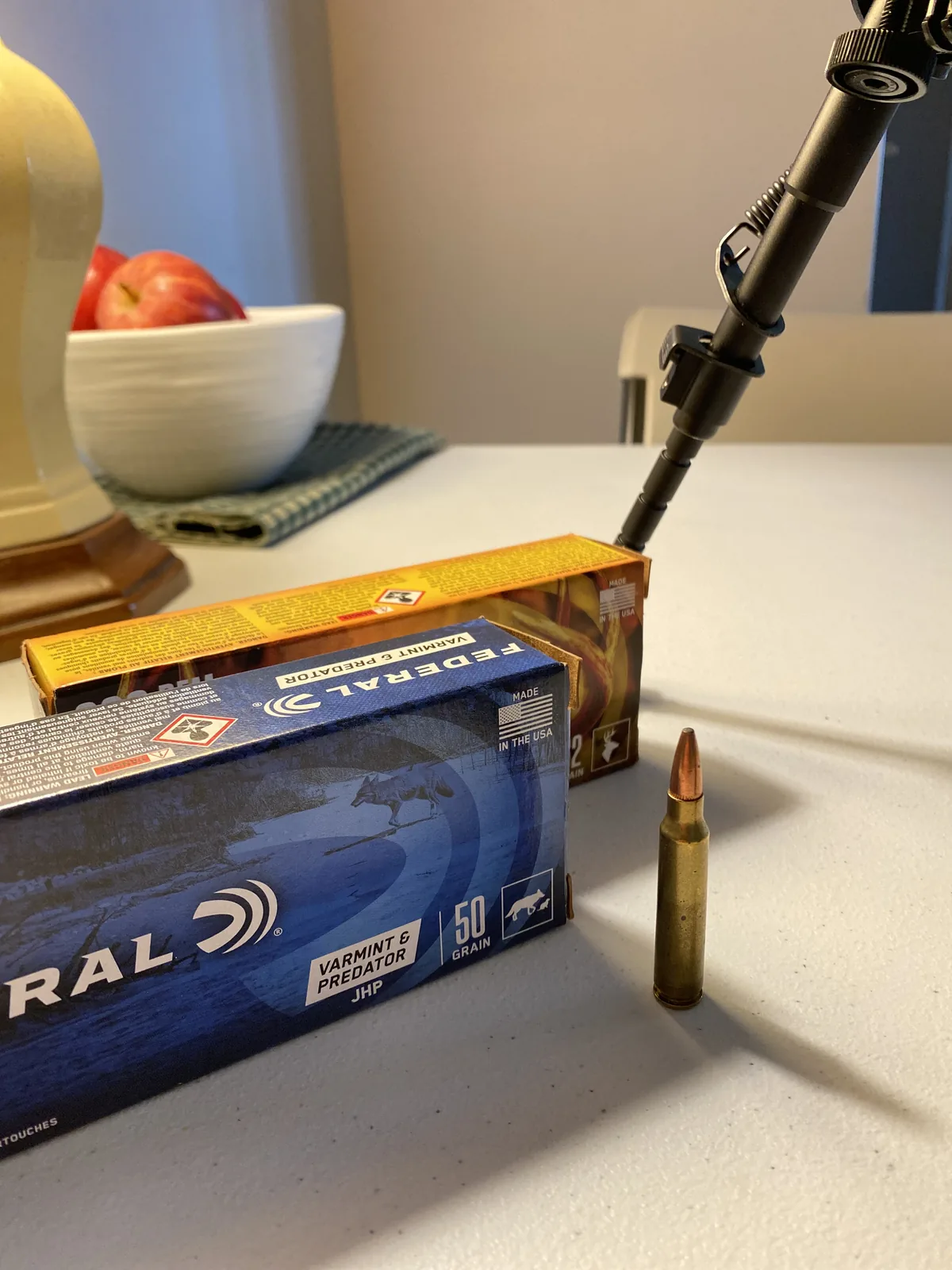 Close-up of the RUGER AMERICAN rollmark on the receiver with the West Hunter scope and rings mounted above