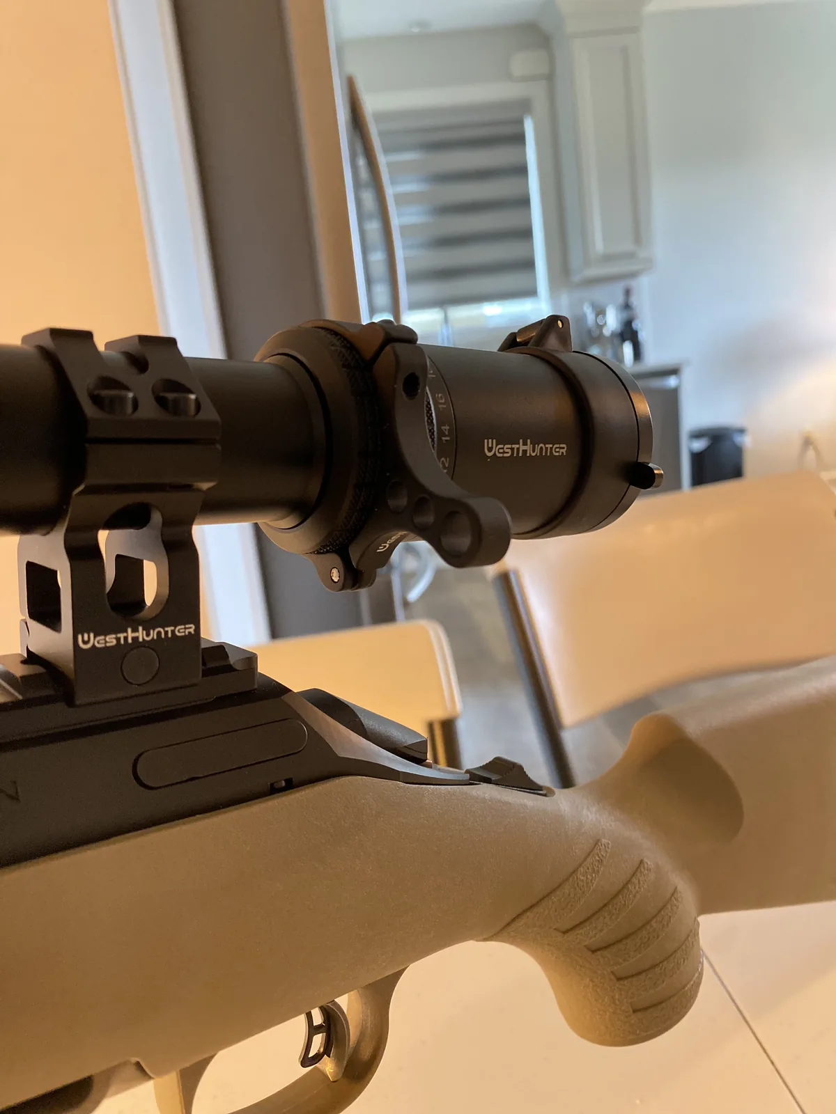 Shooter's hand gripping the textured FDE synthetic stock of the Ruger American Ranch