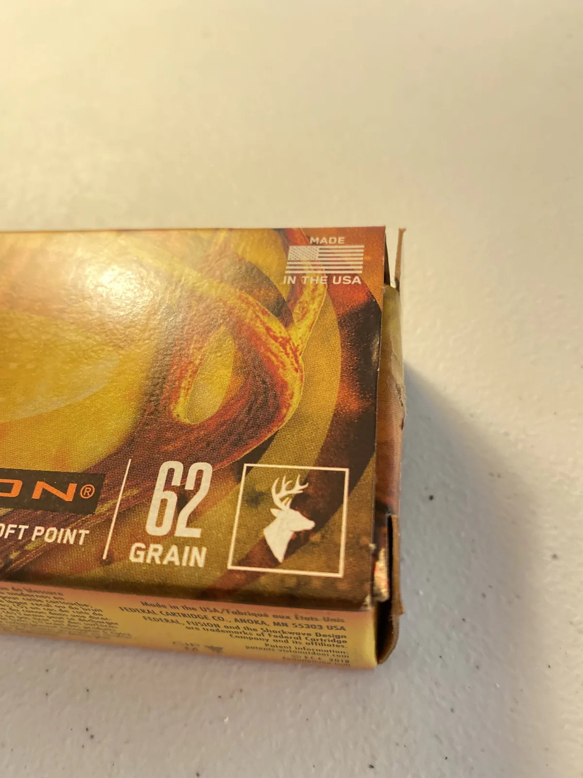 Single .223 cartridge seated in a tinted polymer magazine on a kitchen counter