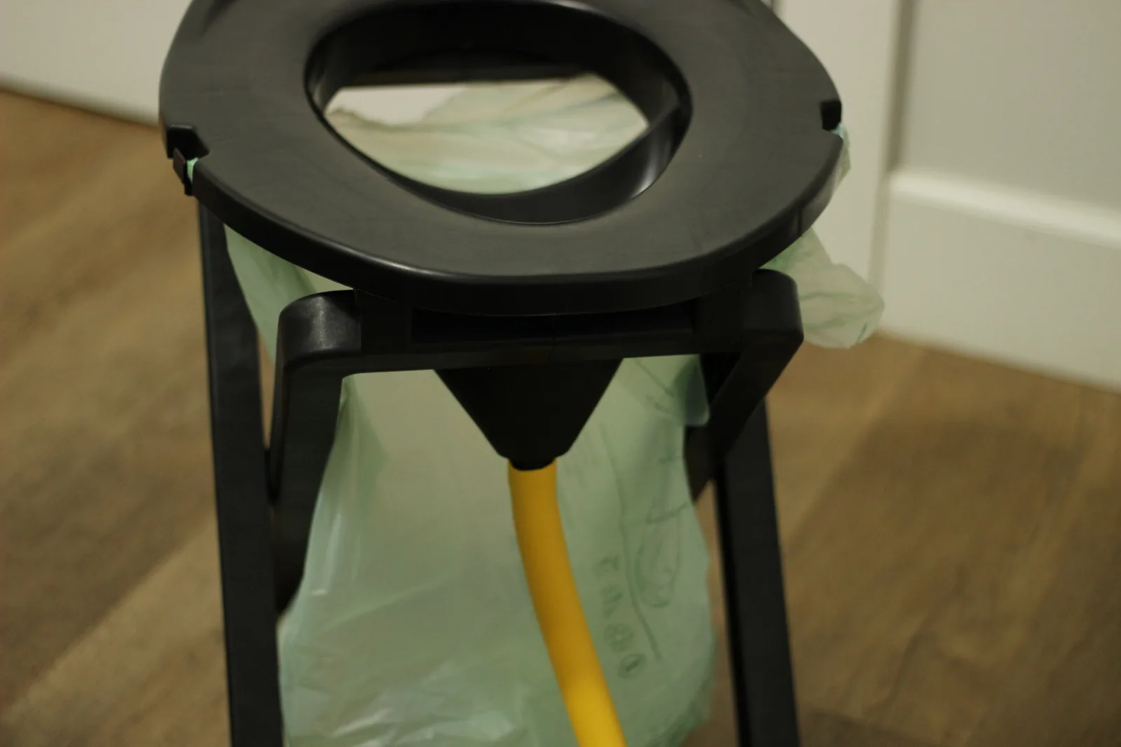 Diagram-style view of the separator showing the front urine collection and rear solids opening