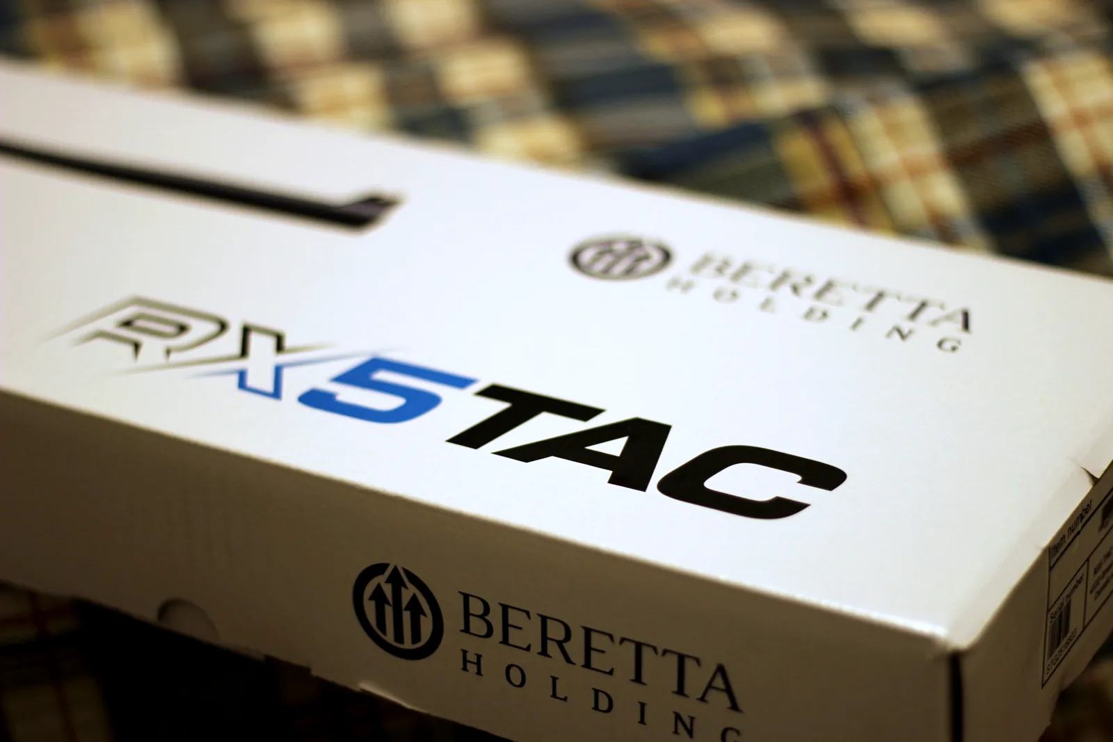 The white RX5 TAC carton with the model name and the Beretta Holding mark printed on the end