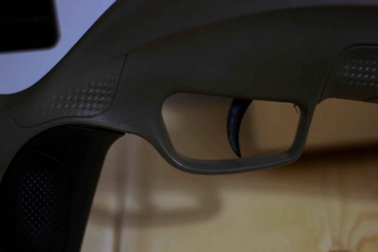 The synthetic stock showing the skeletonised thumbhole area and the trigger guard