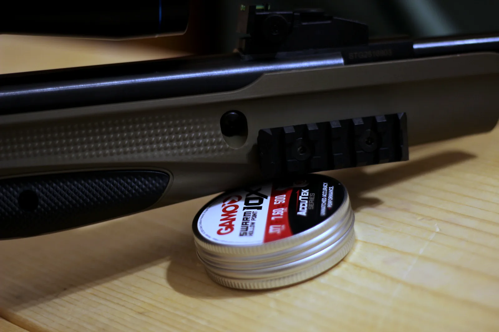 The rifle on the bench beside a tin of pellets