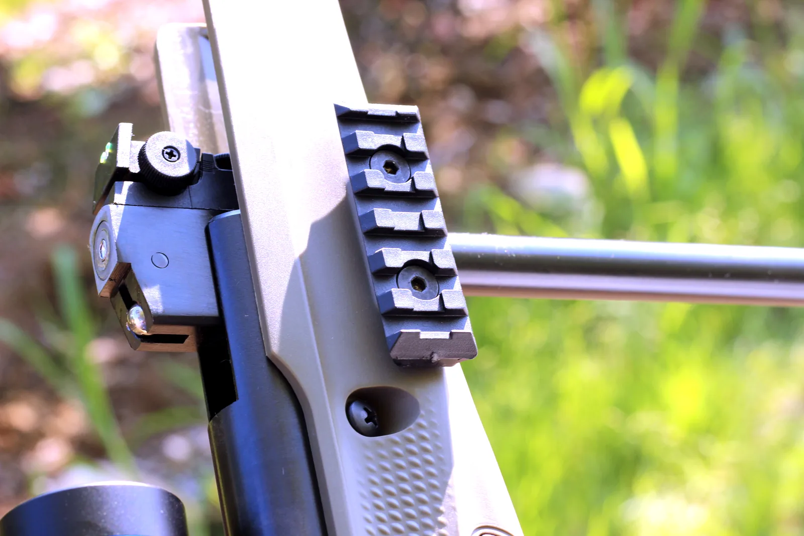 The open breech of the rifle with the accessory rail beneath the forend