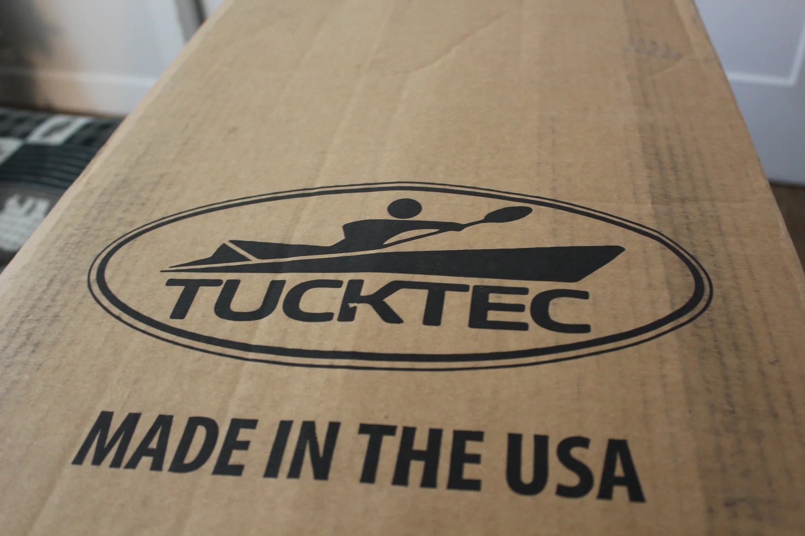 Tucktec retail cardboard shipping box with TUCKTEC logo and MADE IN THE USA printed on the side
