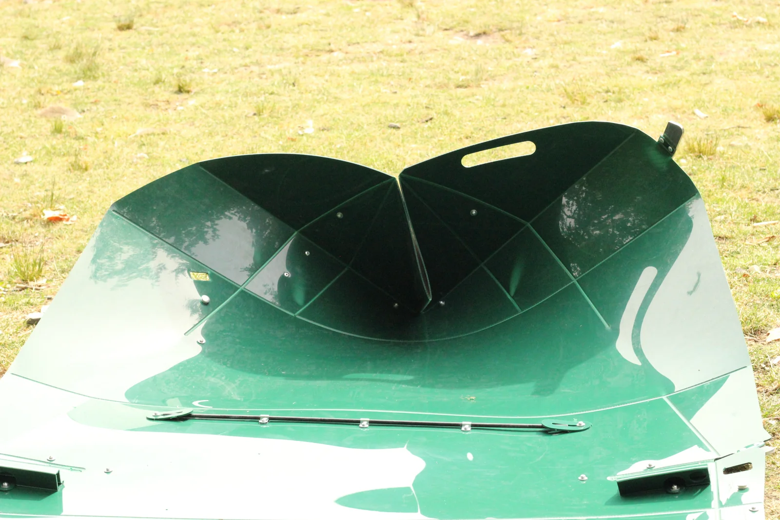 Inside view of the bow of the Tucktec kayak showing two hull panels meeting in a heart-shaped curve with rivets along the seam