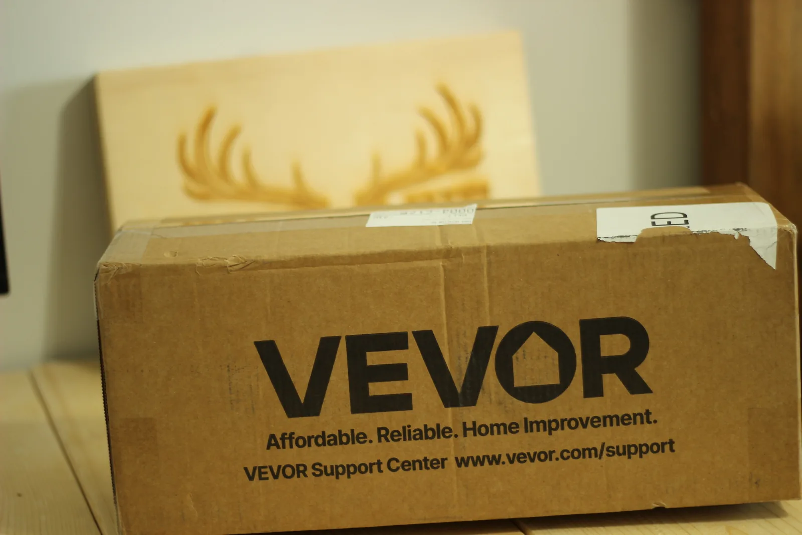 Close-up of the VEVOR logo on the carton with the line Affordable. Reliable. Home Improvement. and the support website below