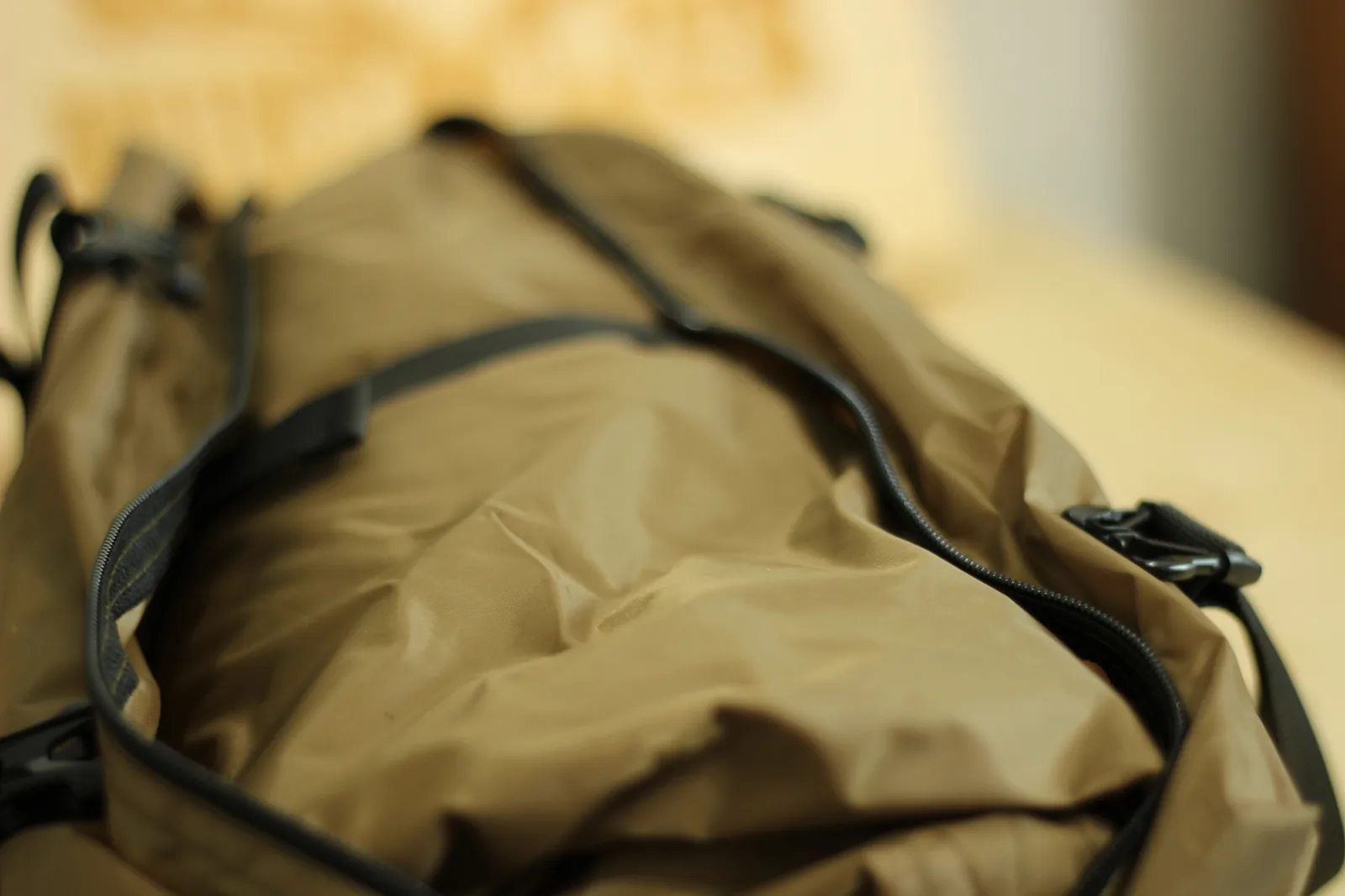 The stuff bag unzipped along its full length showing the packed tent fabric inside