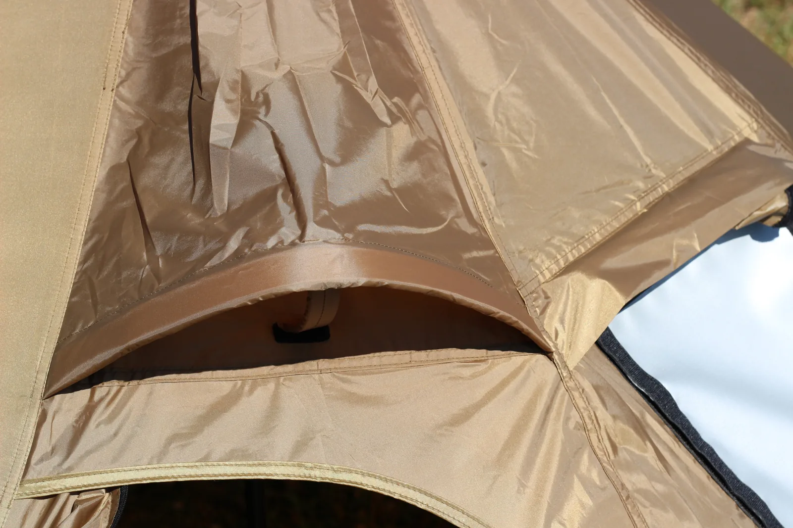 The vent hood on the canopy seen from a lower angle, showing how the flap overhangs the opening