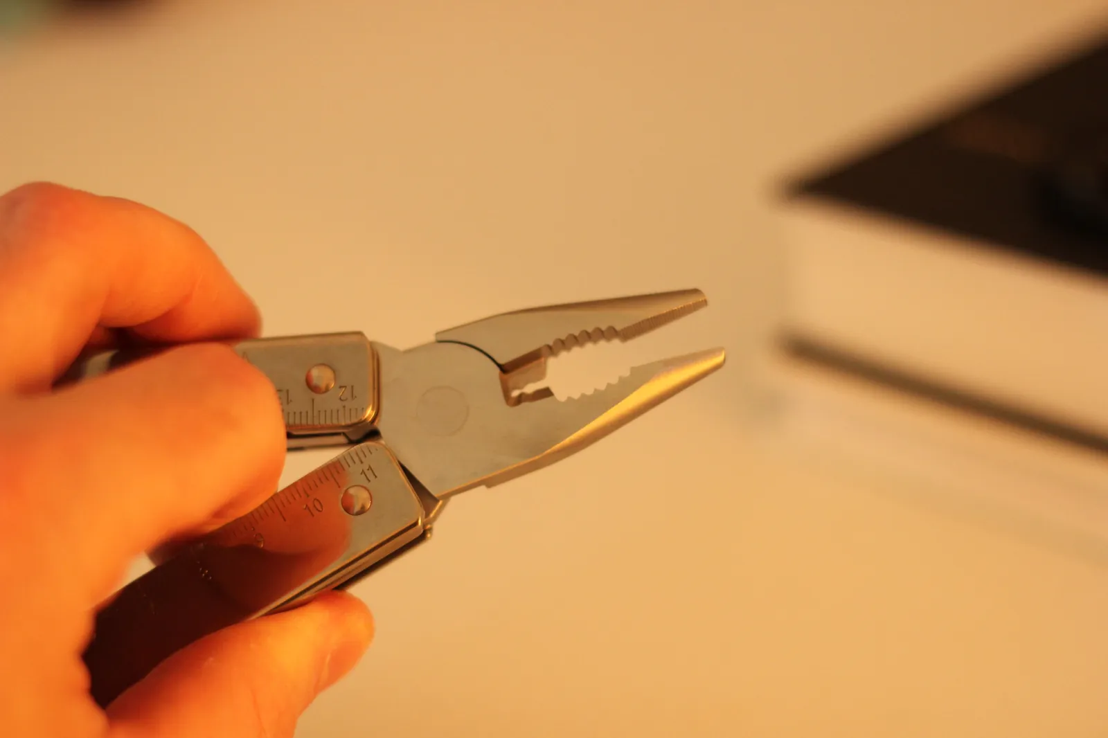 The Swiss Tool MX Clip pliers from a different angle showing the jaw geometry, hard wire cutter notch, and the wire crimper section
