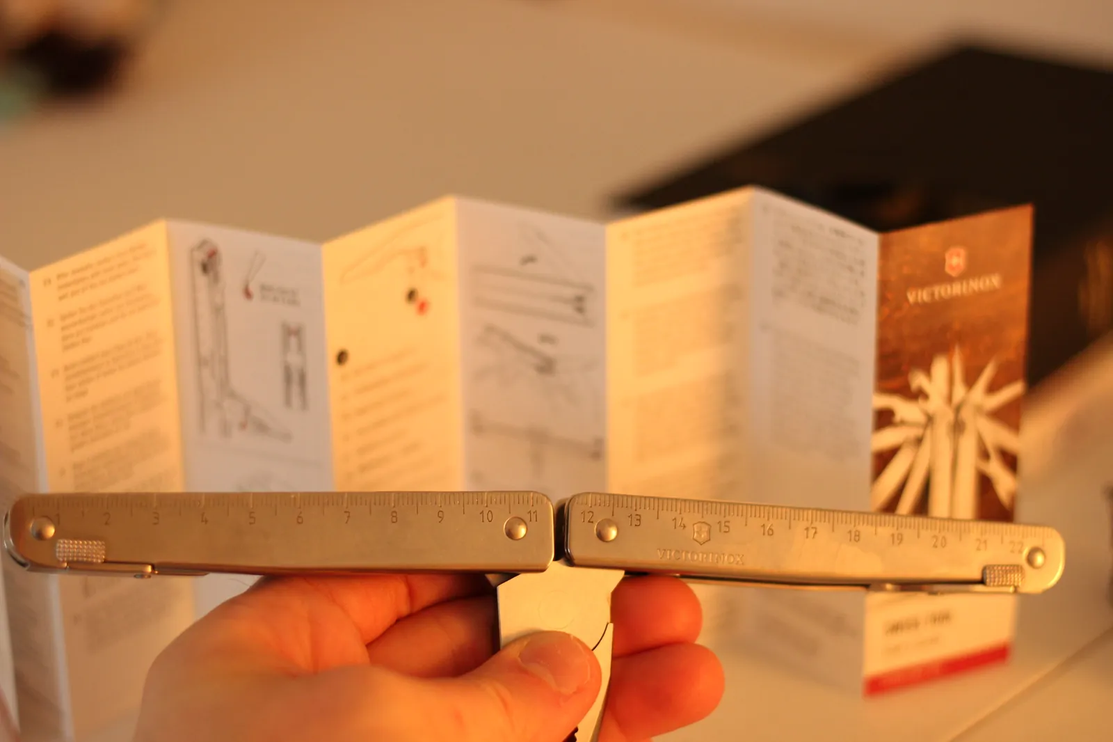 The Swiss Tool MX Clip closed in profile showing the integrated rulers in centimeters and inches along both handles