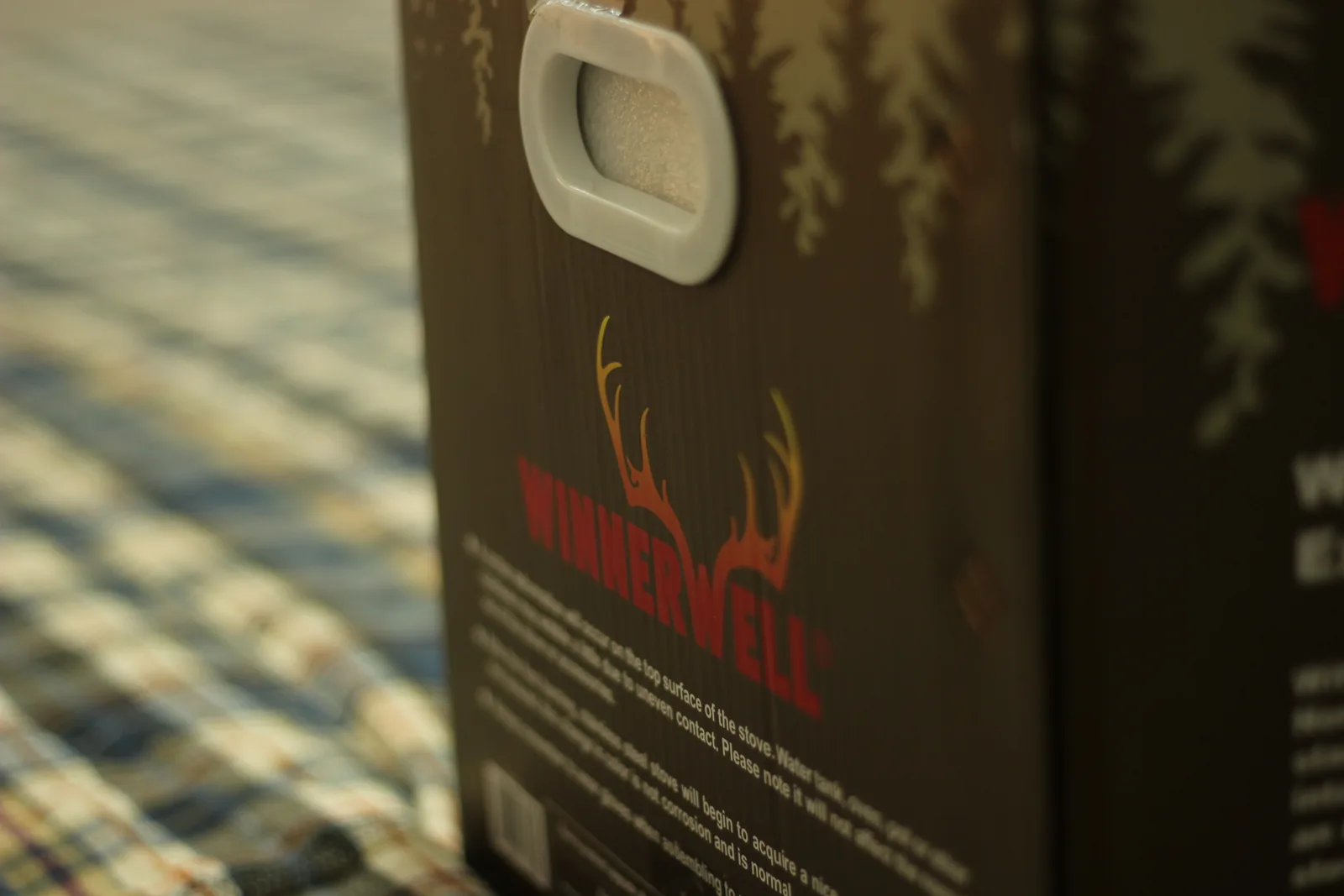The moulded plastic carry handle set into the top of the printed carton
