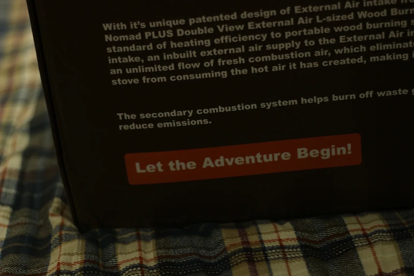 Printed copy on the carton describing the Nomad PLUS Double View External Air L-sized wood burning stove and its secondary combustion system