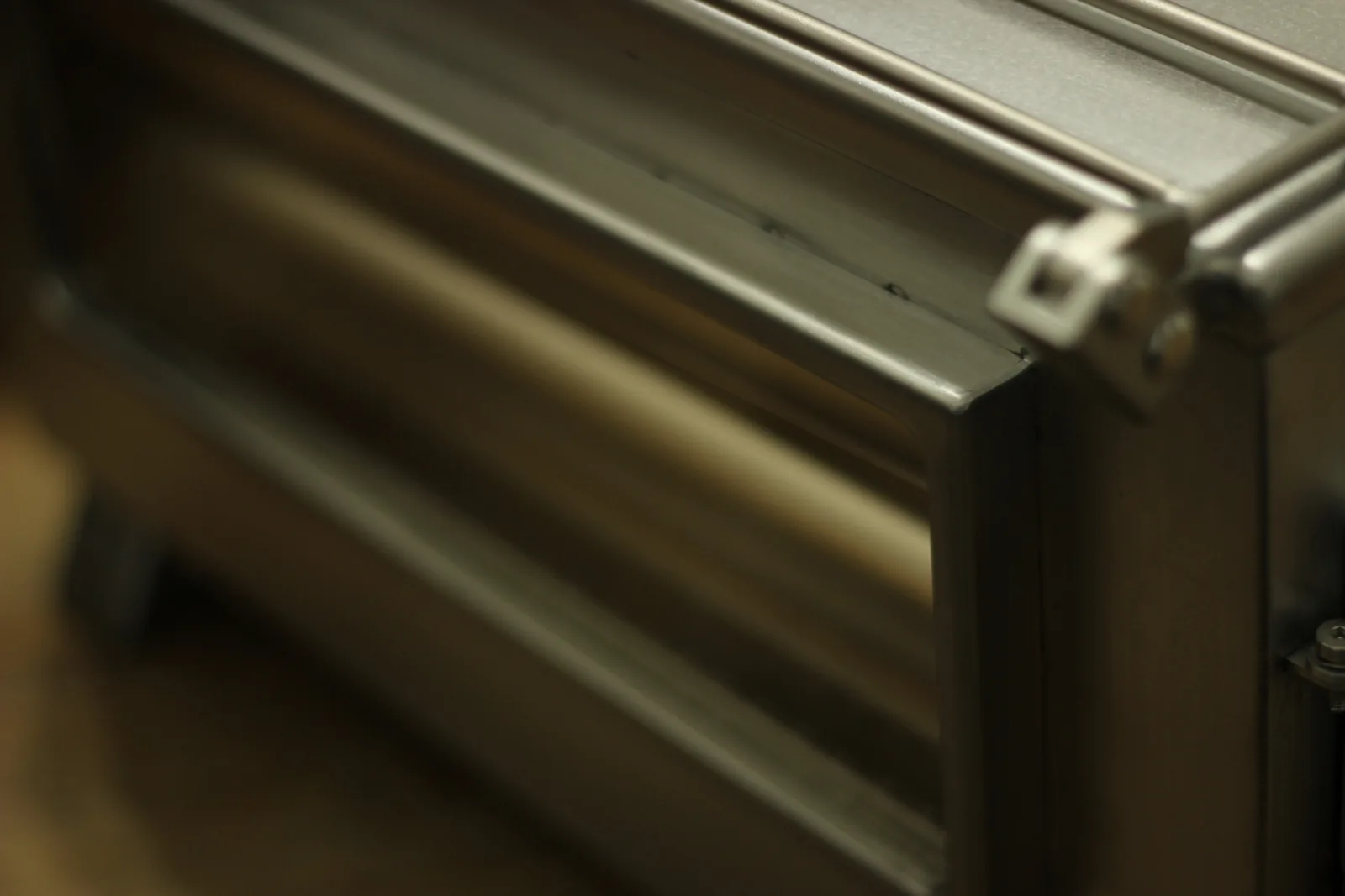 Close-up of the stove body corner showing the folded return and the seam running down the edge