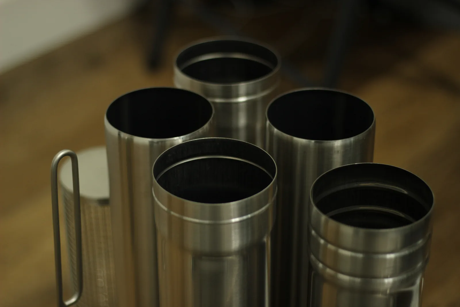 Five chimney sections standing on end showing how they nest one inside another