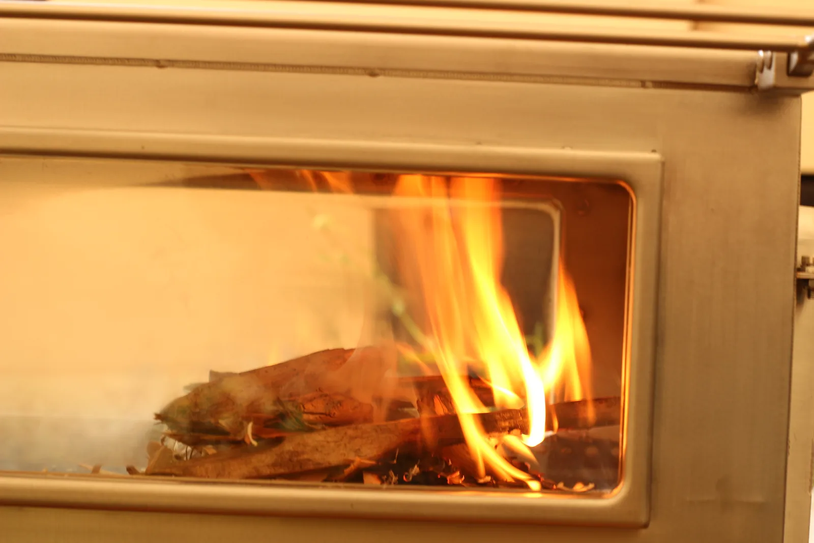 Flames filling the long side window of the stove
