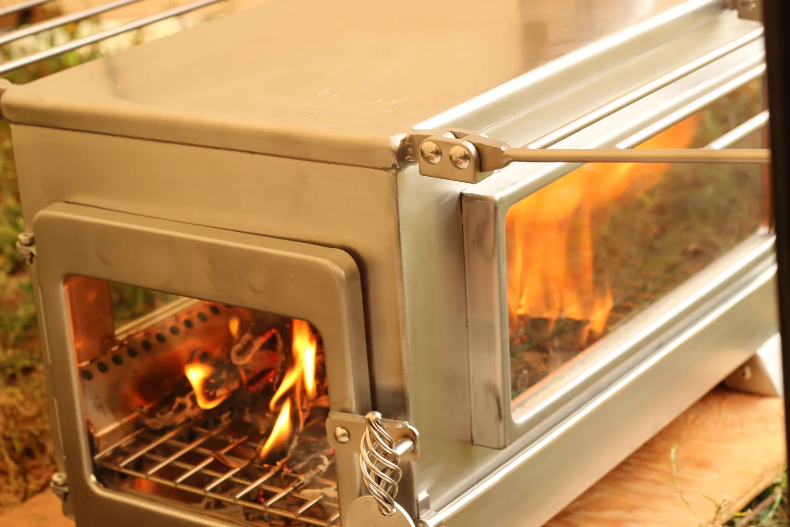 The fire viewed through the front door glass with the wire rack above